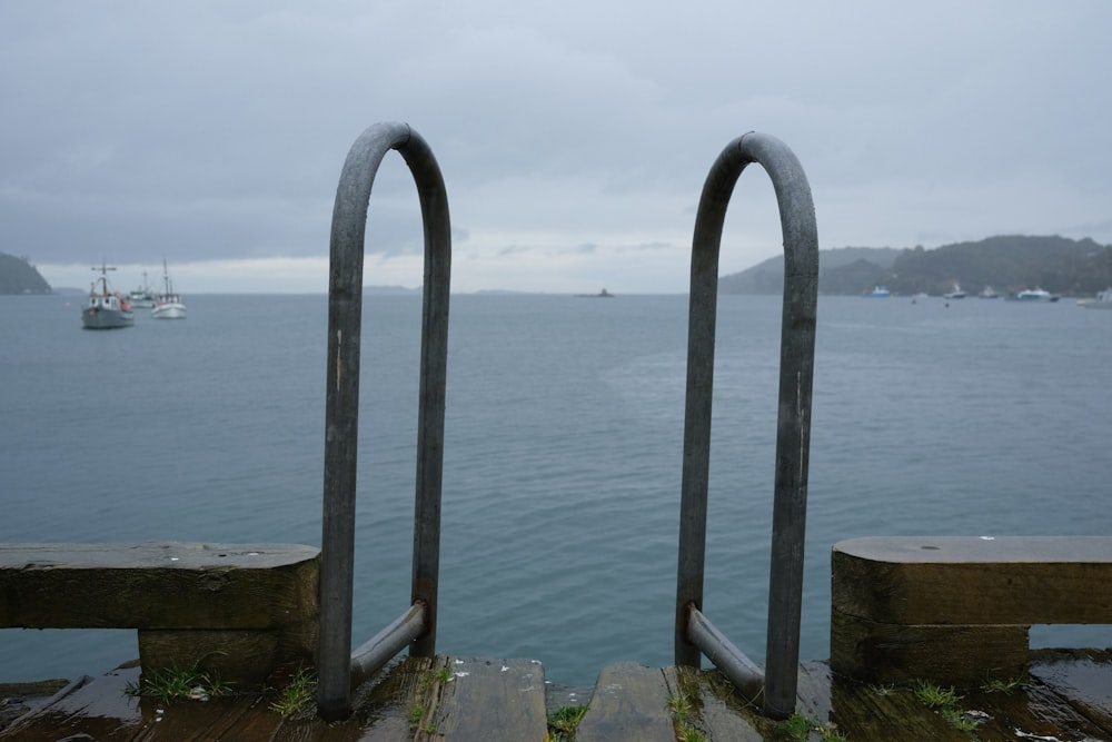 a wooden dock with two metal bars on it