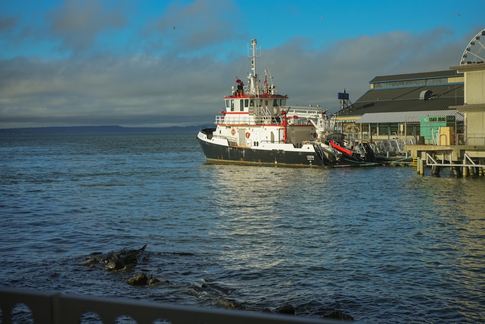 a large boat is docked at a pier