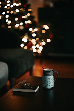 A cozy scene showing a custom photo mug and a framed picture on a wooden table