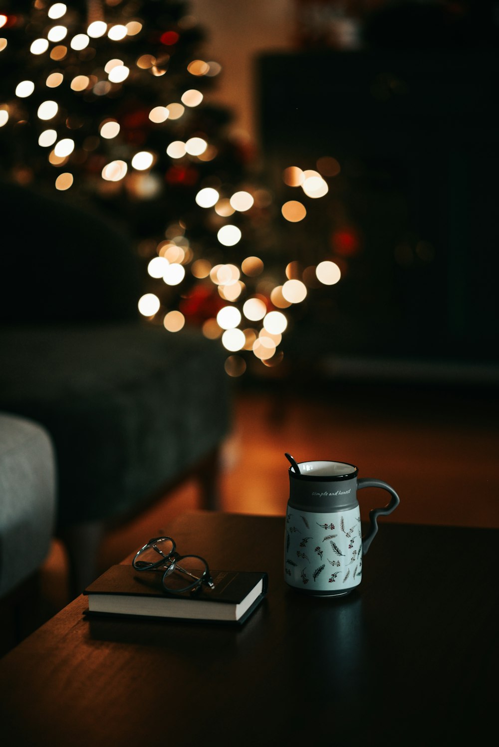 a coffee cup sitting on top of a table next to a book