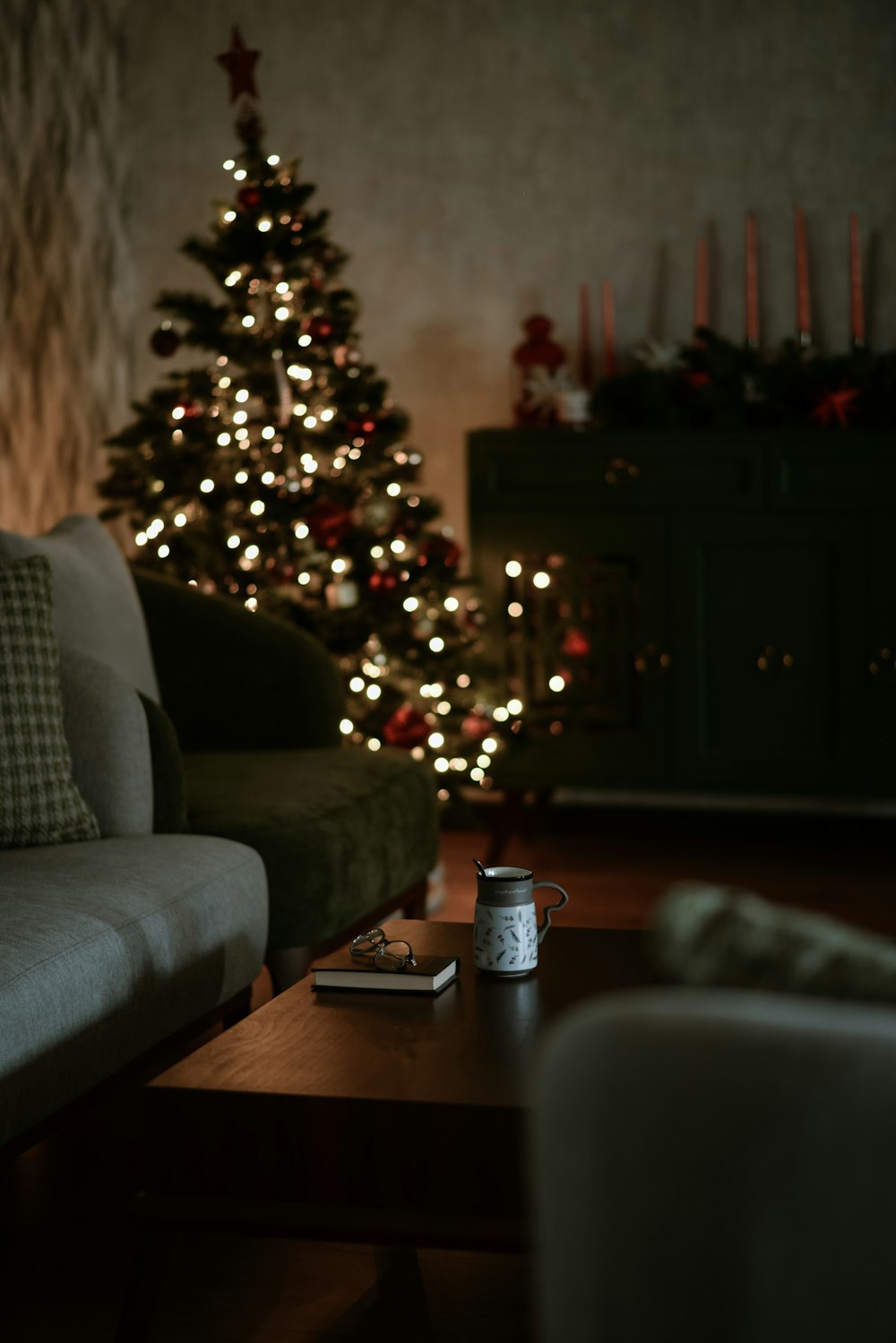 a living room with a christmas tree in the background