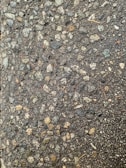 Close-up of freshly crushed stone ready for use in road construction, highlighting texture and quality.
