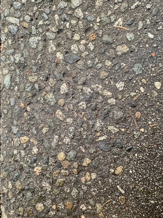Close-up of textured aggregate stones spread evenly on a driveway surface.