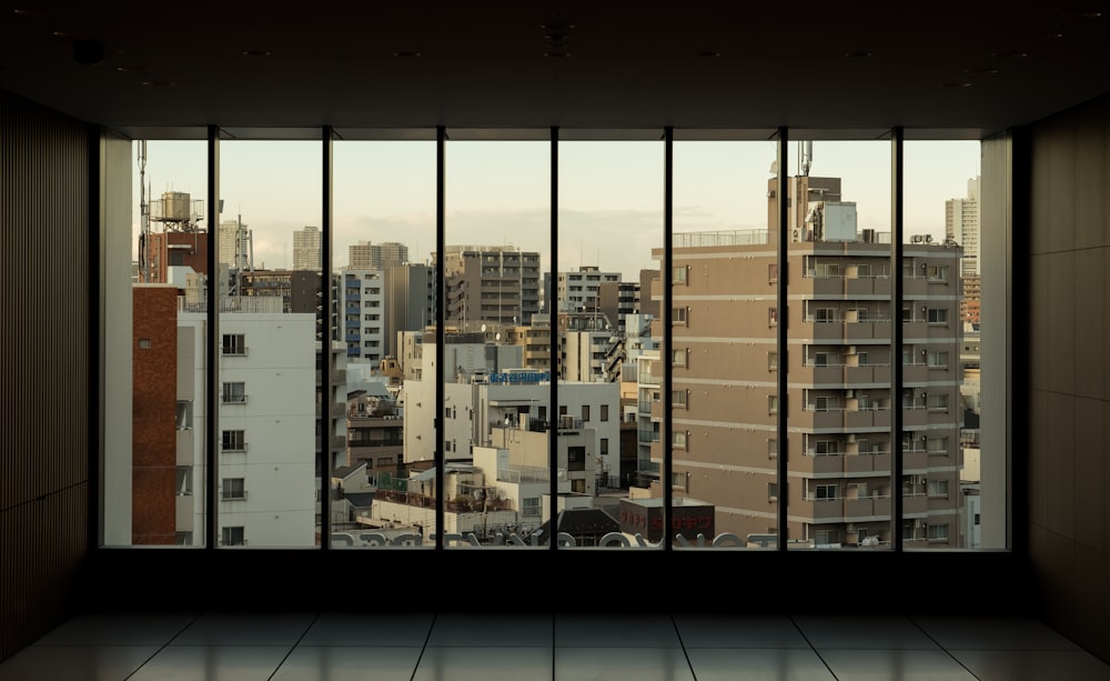 an empty room with a view of a city