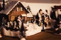 A cozy simulation game screenshot featuring a charming village with animated villagers.