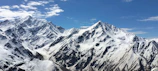 Snow-capped peaks towering under a clear blue sky.
