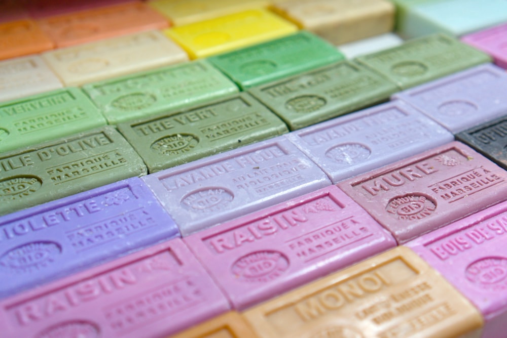 a close up of many different colored bars of soap
