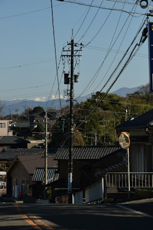 A residential street with mountains in the background, similar to neighborhoods along the edges of the Las Vegas valley