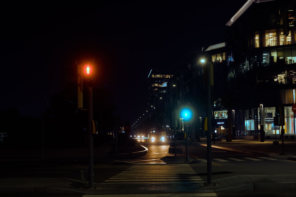 a city street at night with traffic lights