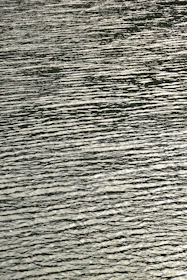 A serene swirl of clear water reflecting soft light, symbolizing soothing care.
