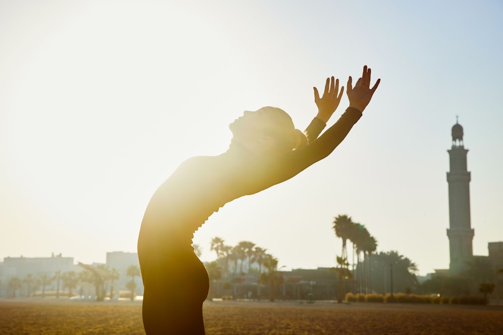 a person reaching up to catch a frisbee