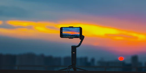 A cinematic shot of a creator filming vibrant street scenes in a Latin American city at sunset