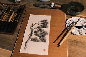 A serene studio workspace with Taoist talismans, brushes, and ink arranged neatly on a wooden table