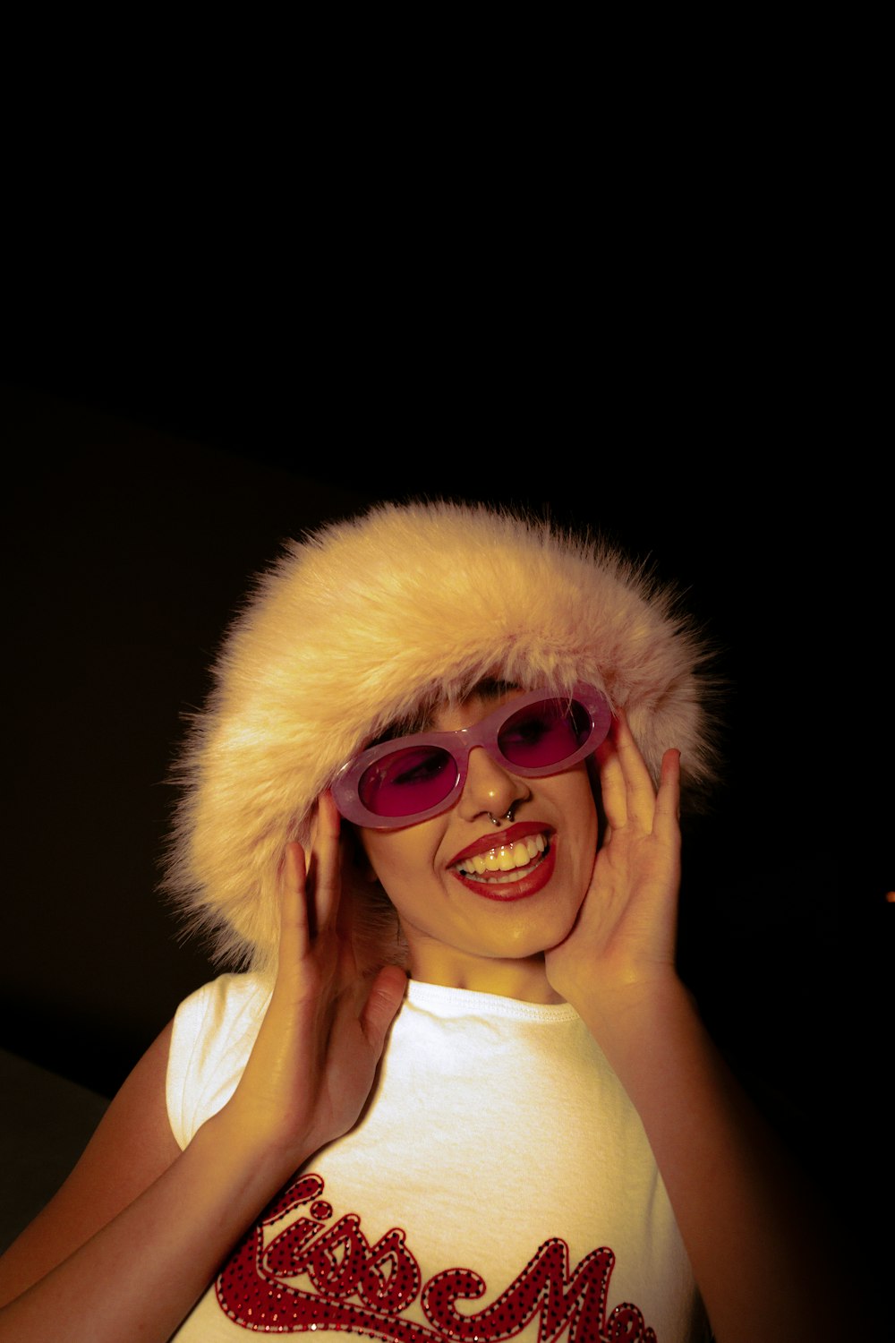 a woman wearing sunglasses and a fur hat