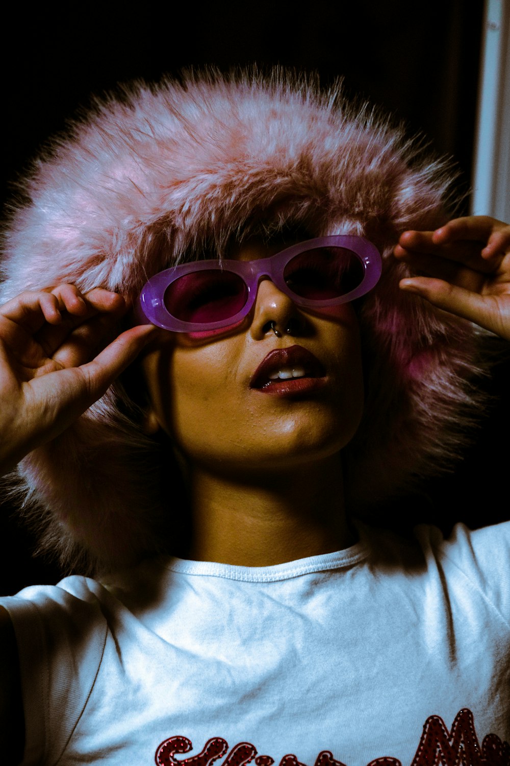 a woman wearing sunglasses and a fur hat