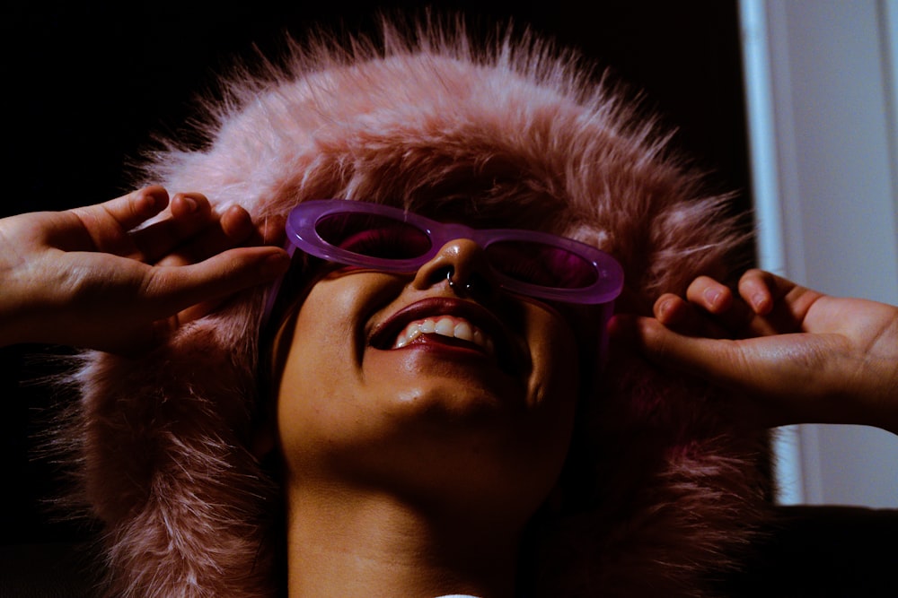 a woman wearing glasses and a fur coat