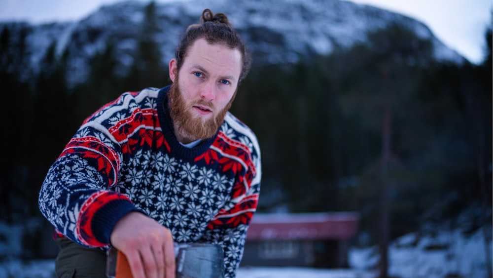 a man with a beard is holding a skateboard