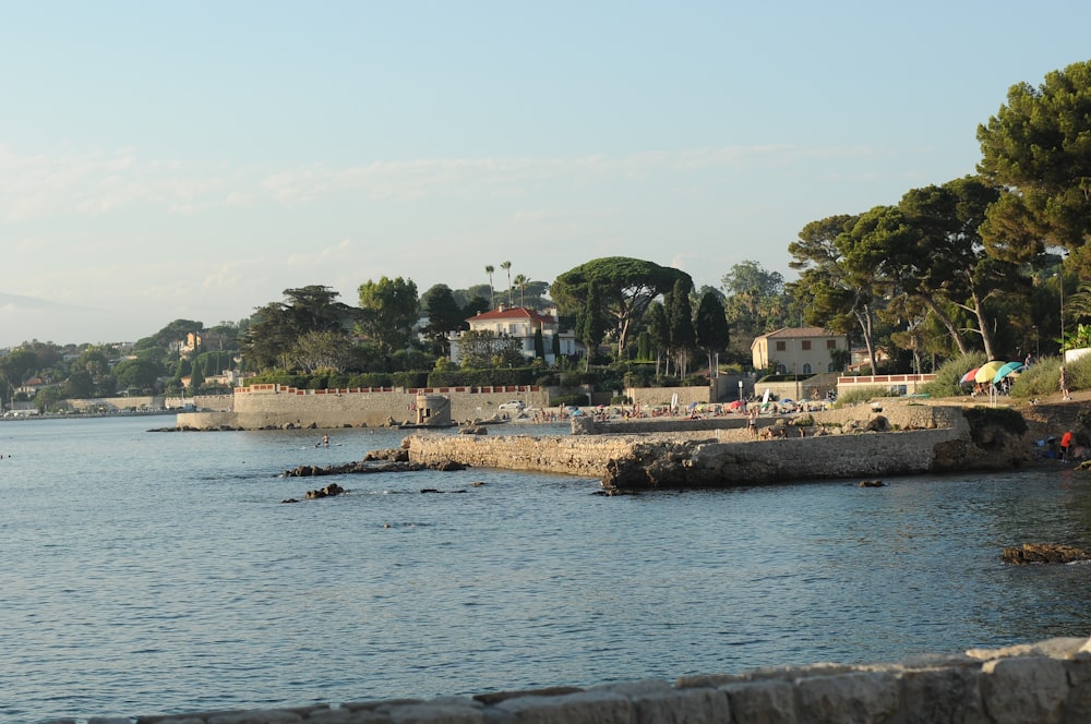 a large body of water with houses in the background