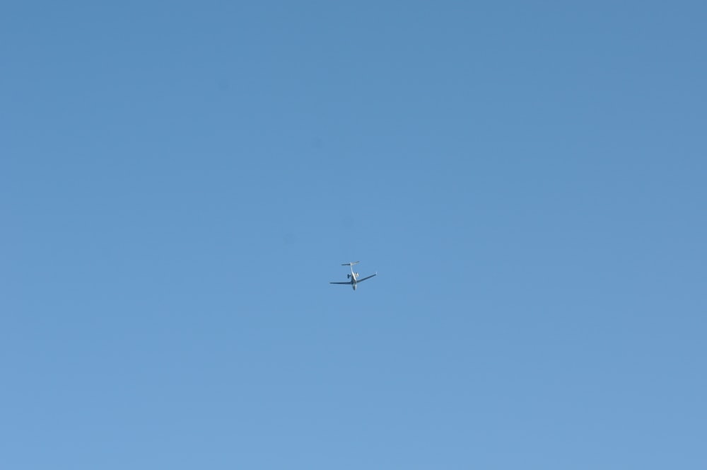 an airplane is flying high in the sky