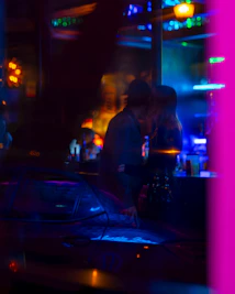 An intimate scene from a nocturna webcomic featuring vibrant characters under moody lighting.