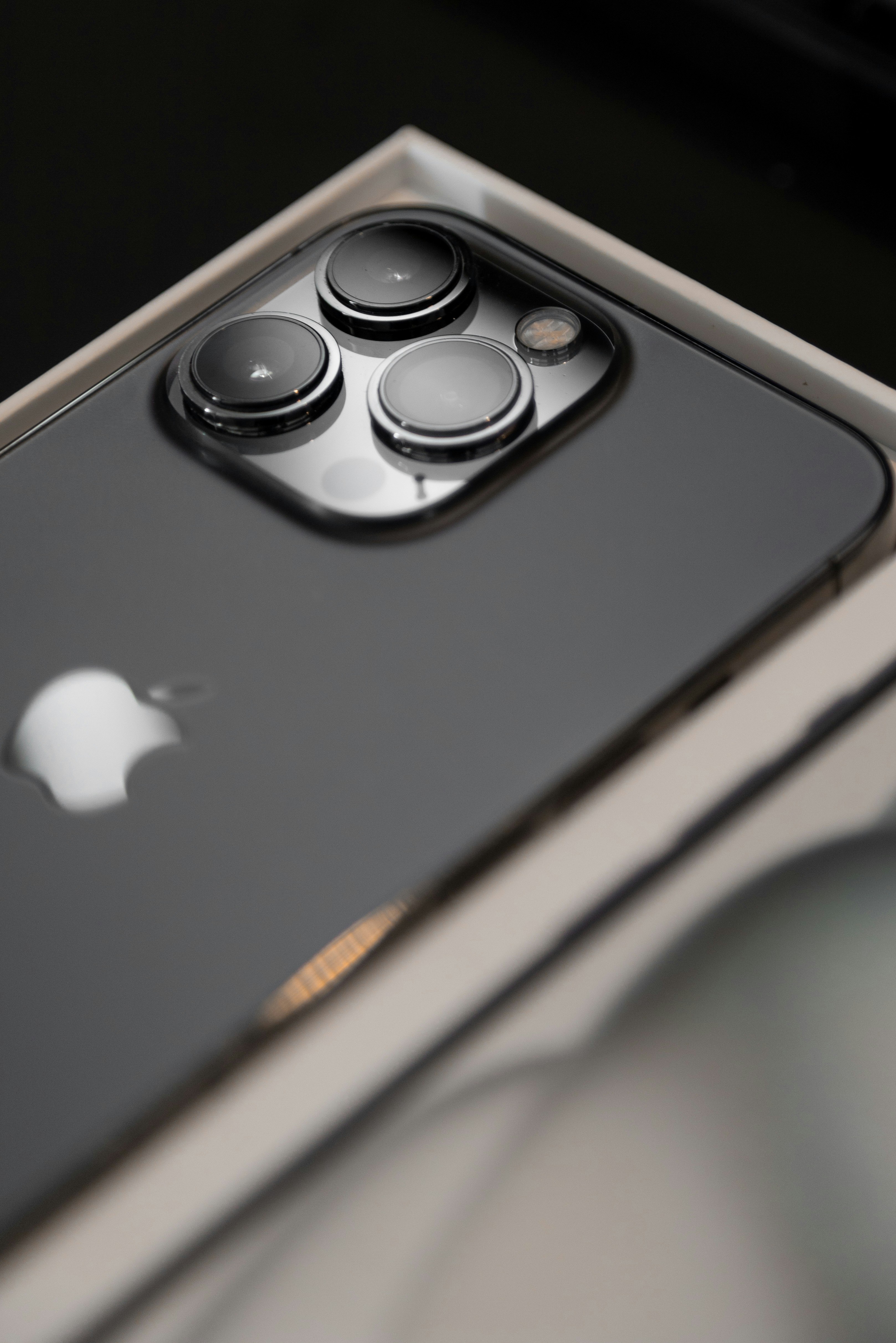 a close up of a cell phone with an apple logo on it