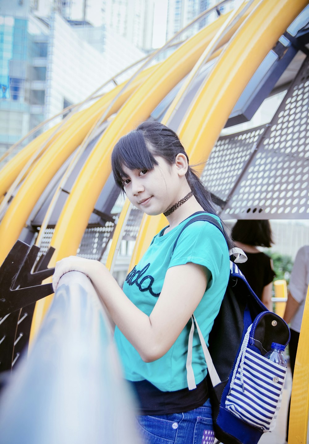 a woman with a blue shirt and a blue backpack