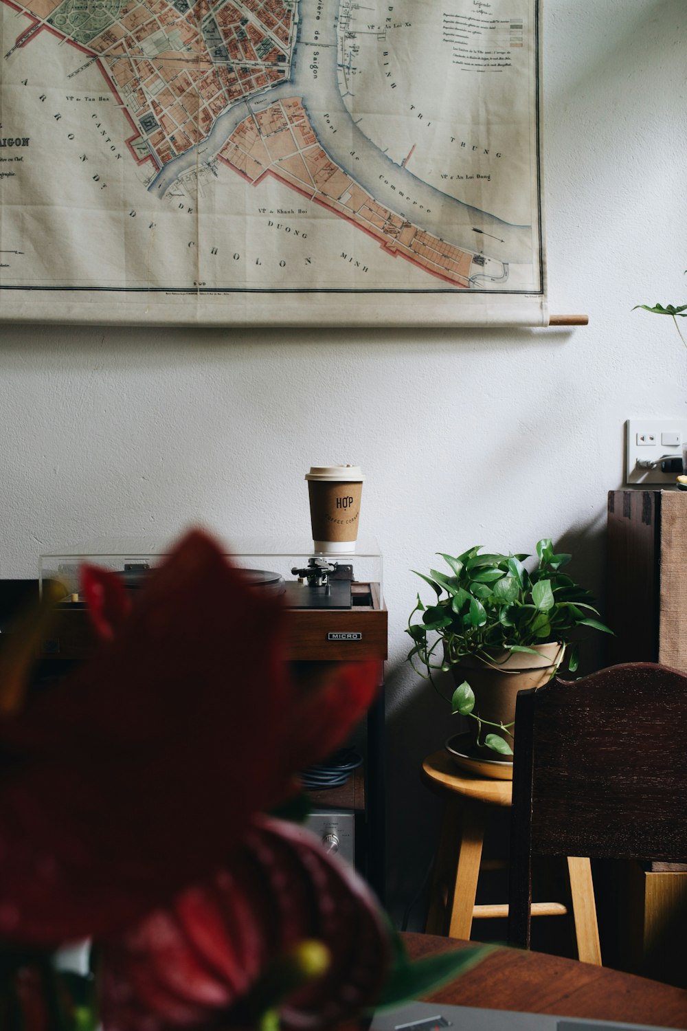 a map hanging on a wall above a table