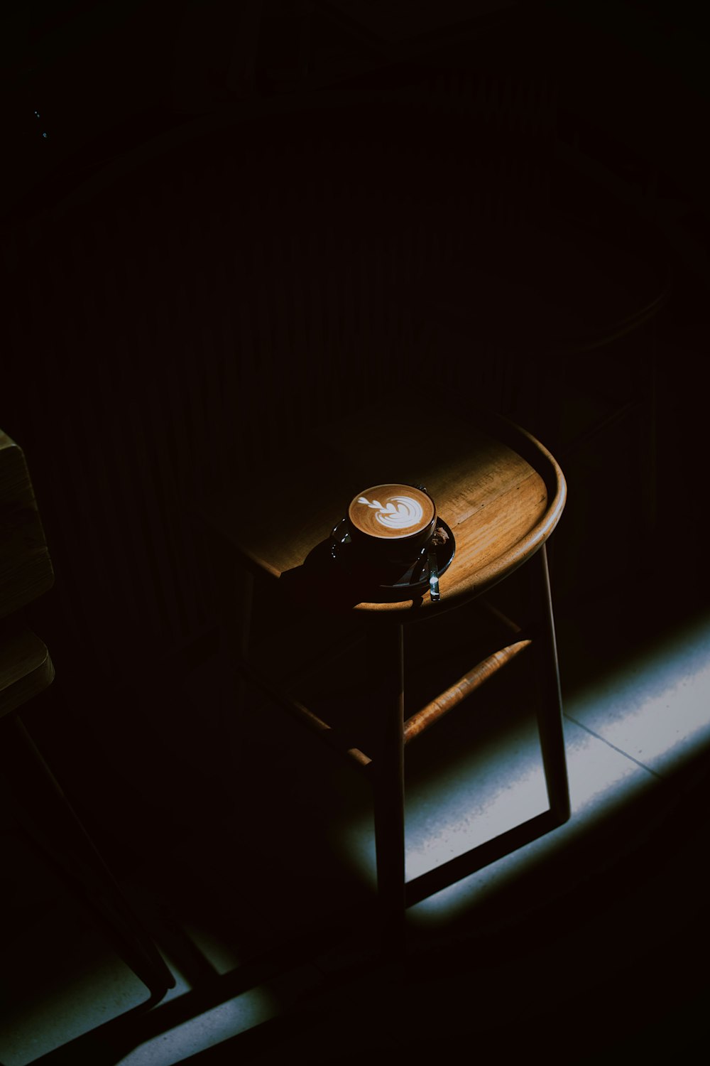 a wooden table with a coffee cup on top of it