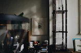 A sunlit urban apartment nook with a carefully arranged coffee setup and plants.