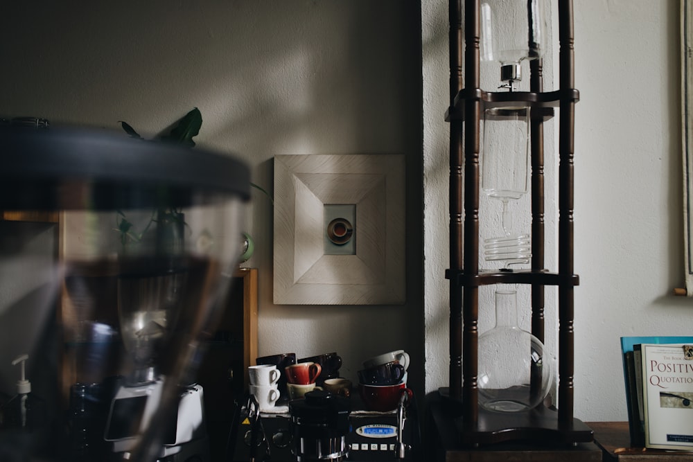 a room with a shelf, a chair, and a painting on the wall