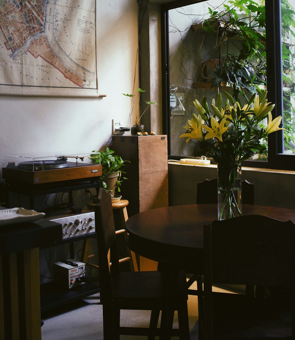 a table with a vase of flowers on top of it