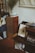 A cozy reading nook featuring a stack of books next to a vintage vinyl record player.