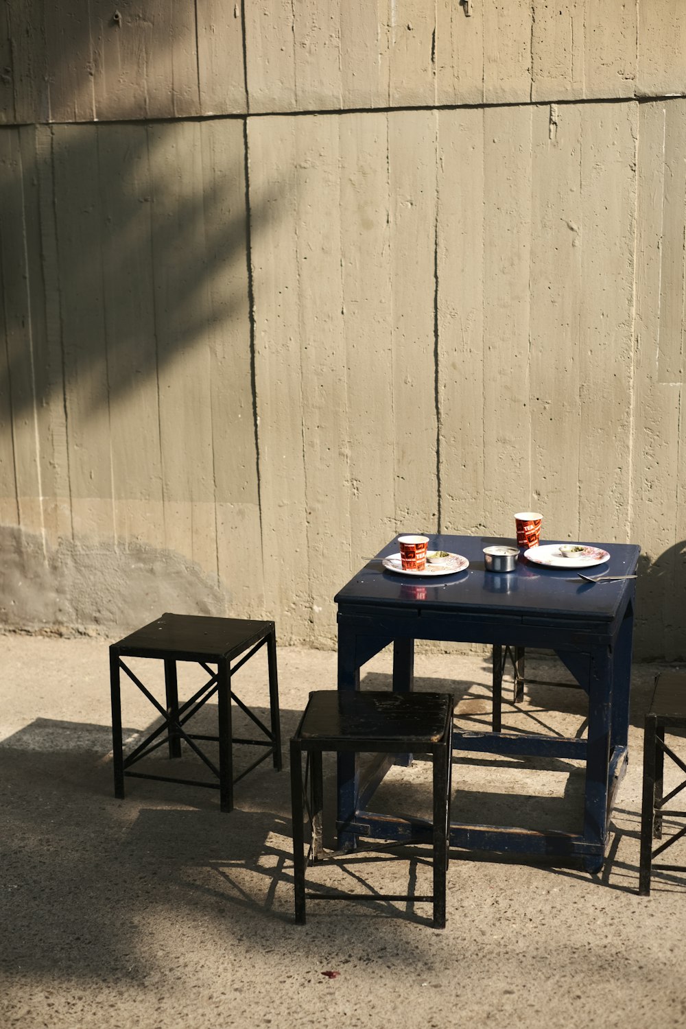 a table and chairs with plates of food on them