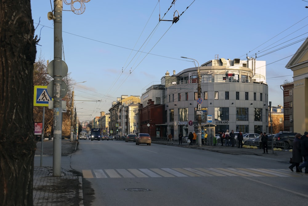 a city street filled with lots of traffic next to tall buildings