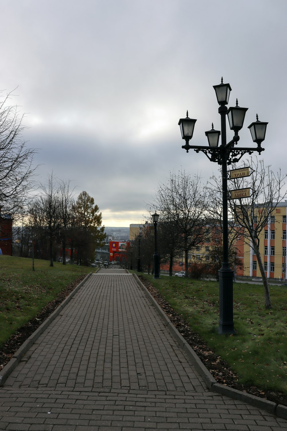 a brick path leading to a street light