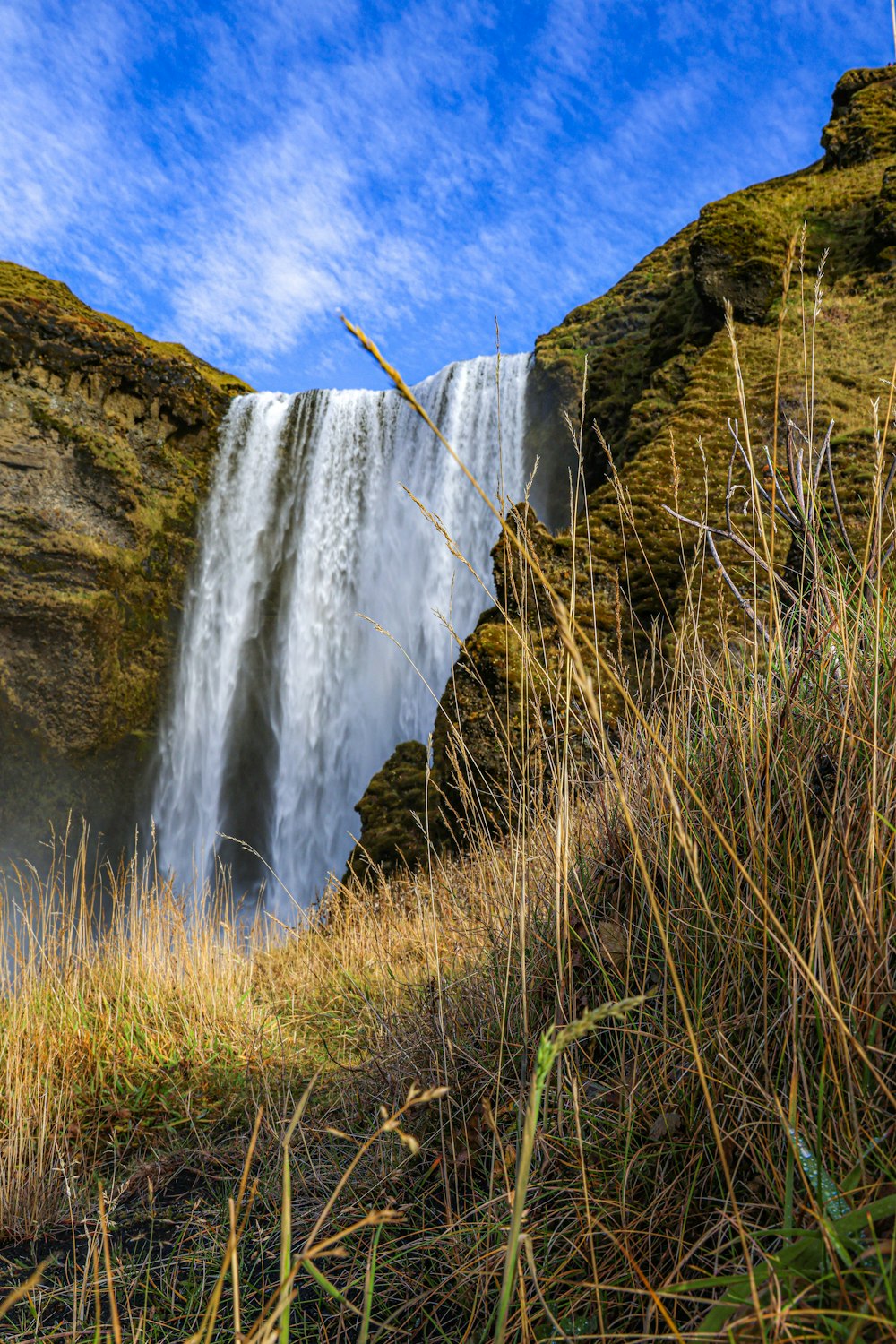 a waterfall with water falling off of it's sides