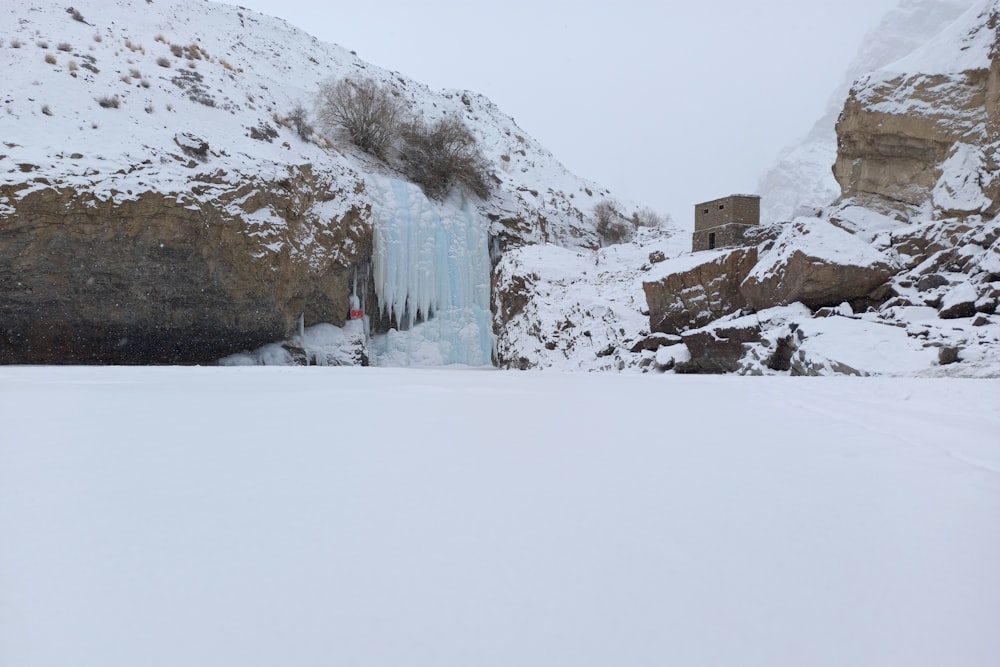 a frozen waterfall in the middle of a snowy landscape