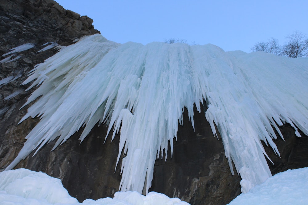 the ice is hanging off the side of the mountain