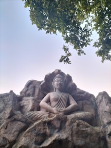 A serene image of a traditional Indian guru meditating in a peaceful natural setting.