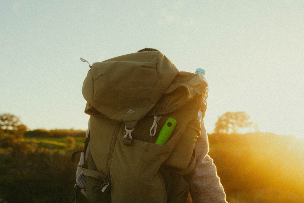 a person with a backpack and a green toothbrush