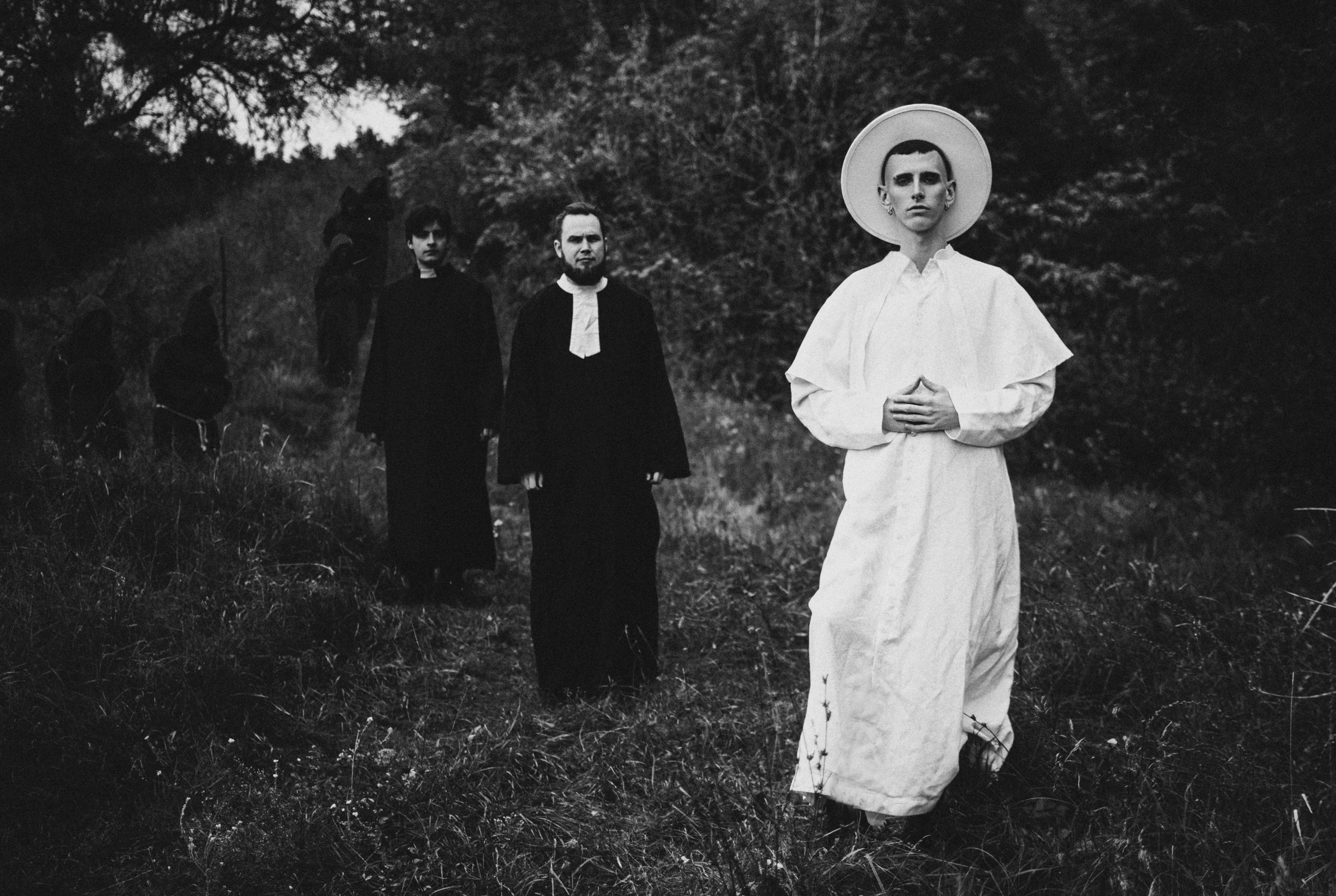 a black and white photo of a group of people standing in a field