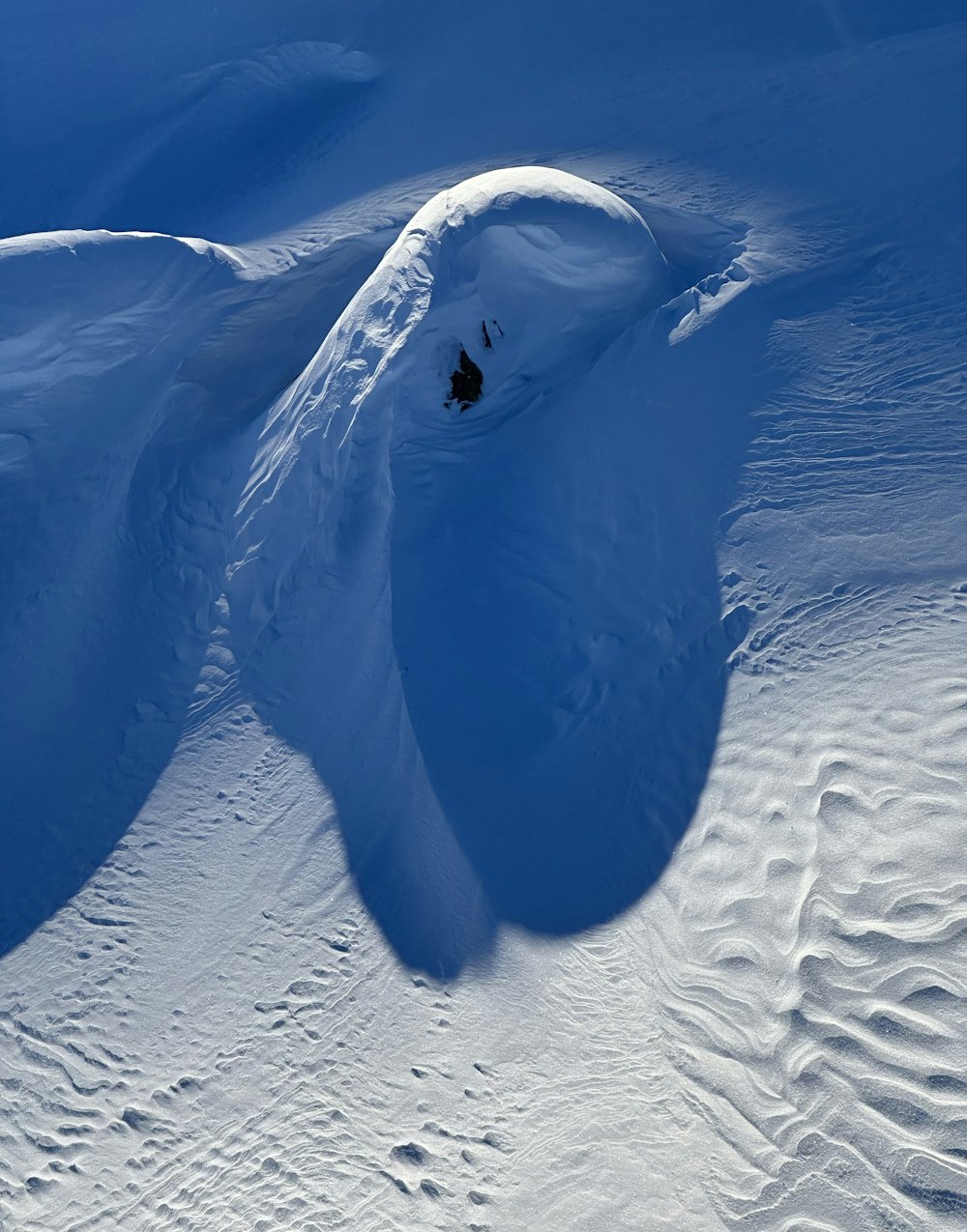 a person riding skis down a snow covered slope