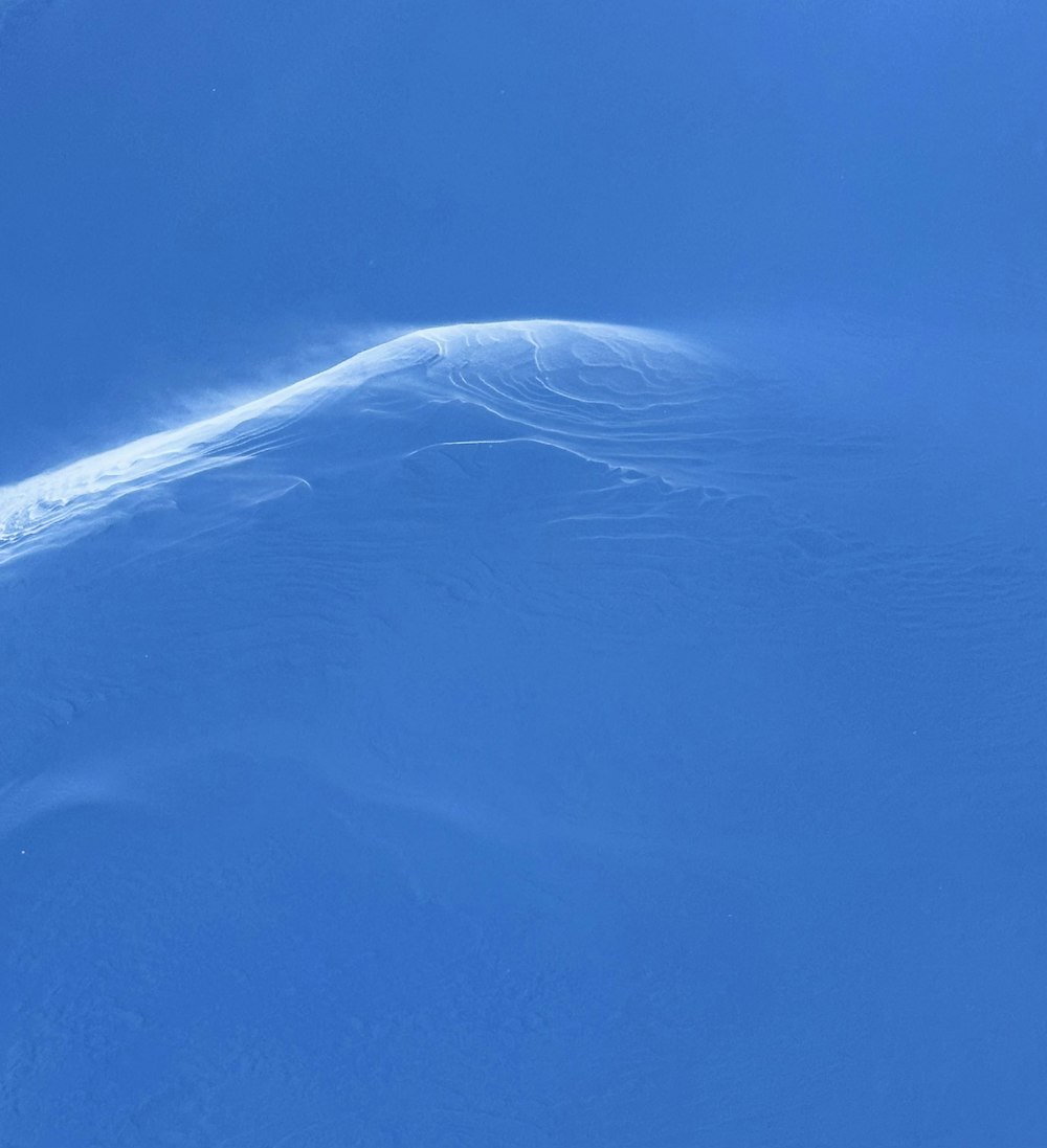 a person riding skis down a snow covered slope