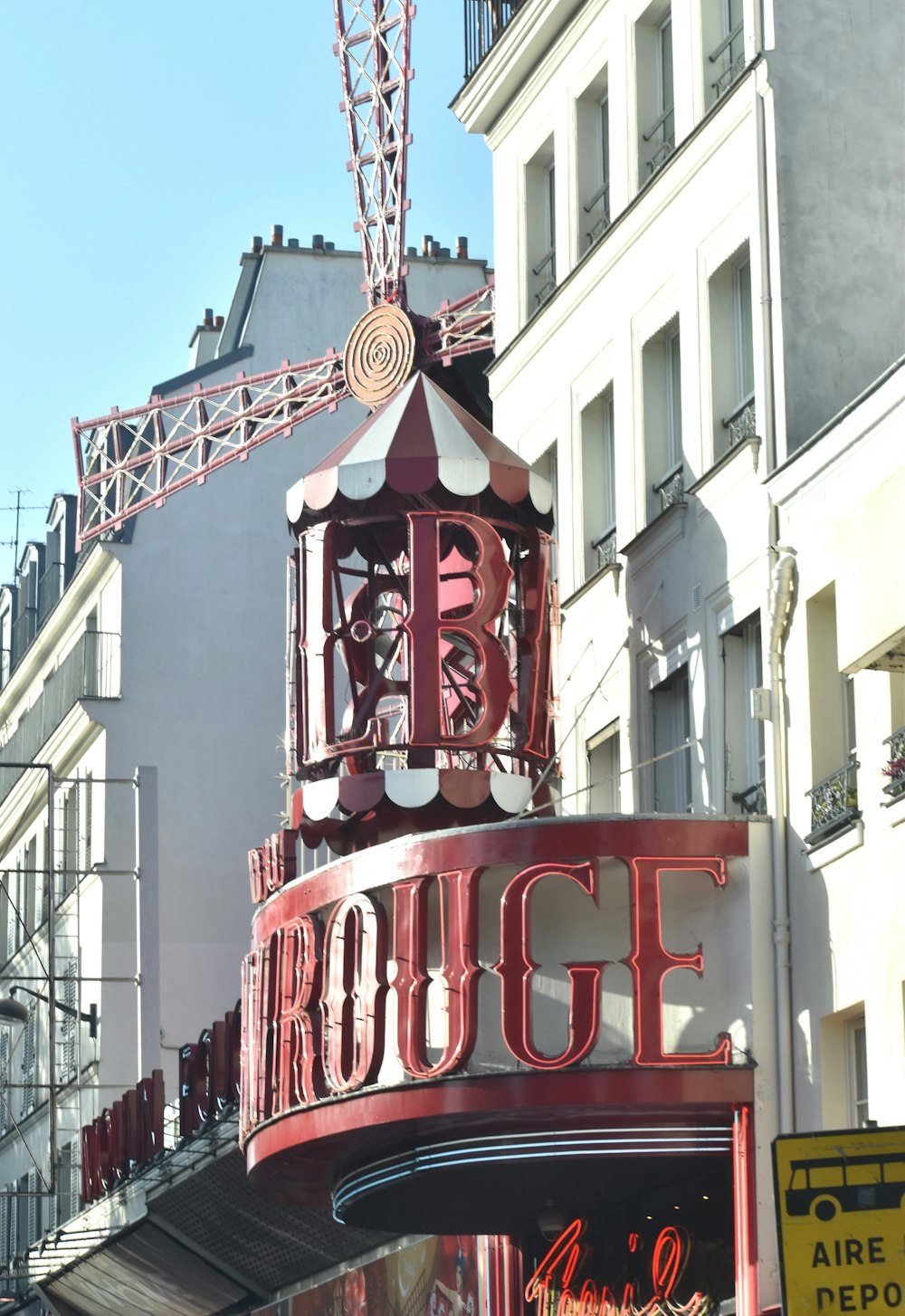 a large red sign on the side of a building