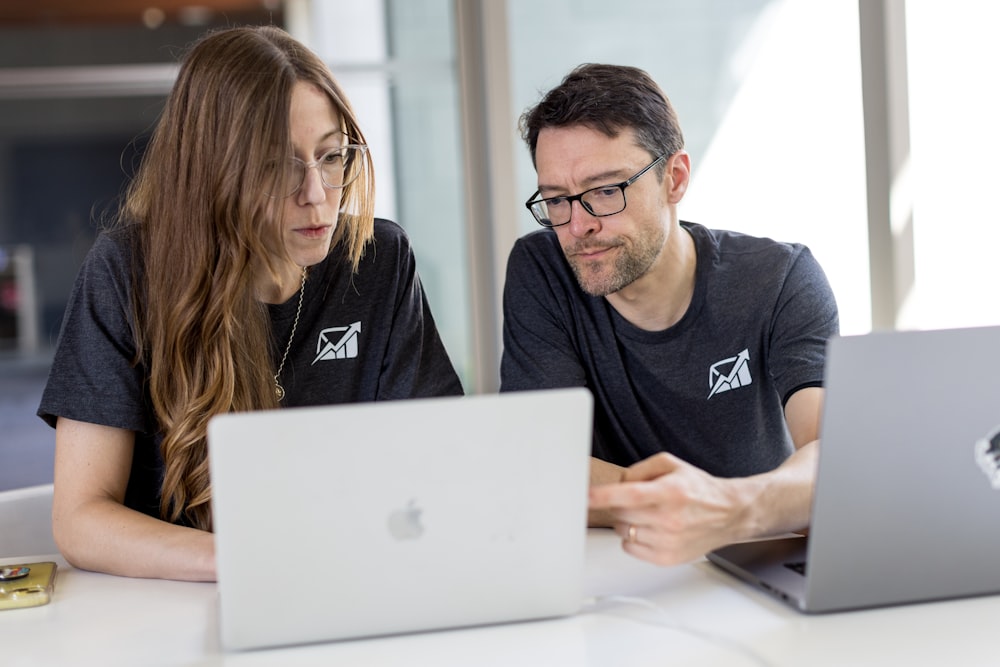 a man and a woman looking at a laptop