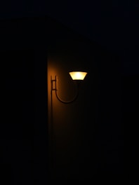 A warm glass outdoor wall light illuminating a cozy porch area