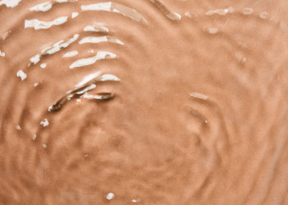 a close up of a brown substance in the water