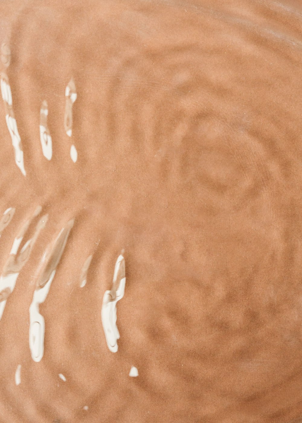 a close up of a person's hand in a puddle of water