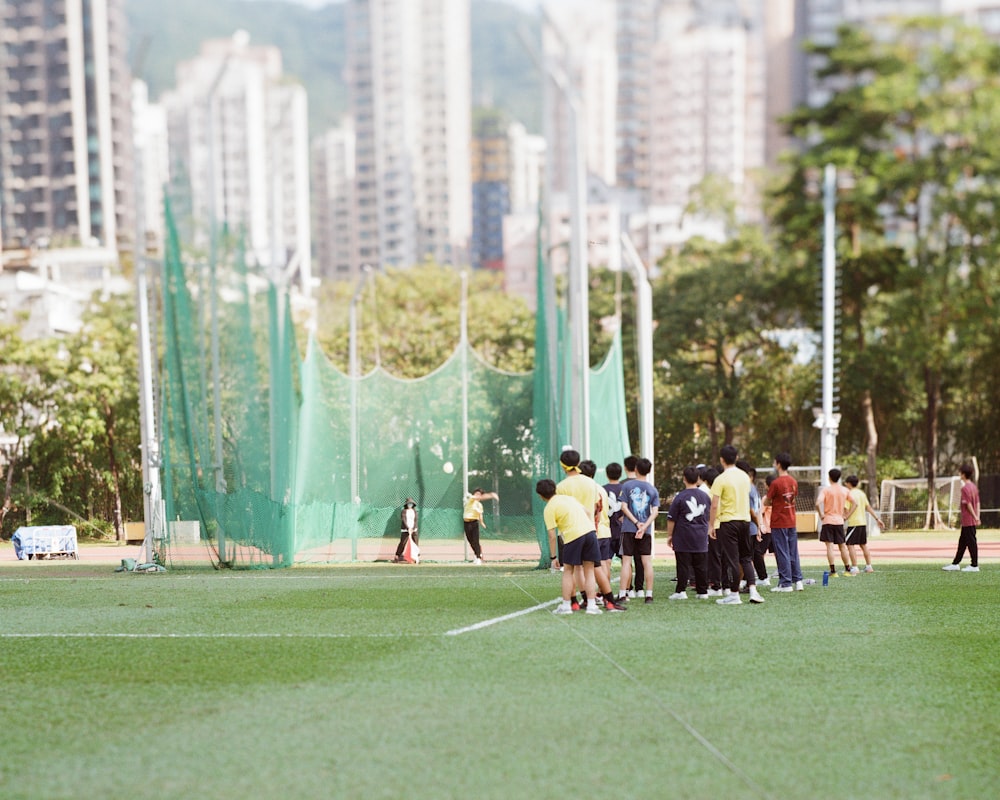 a group of people standing on top of a soccer field