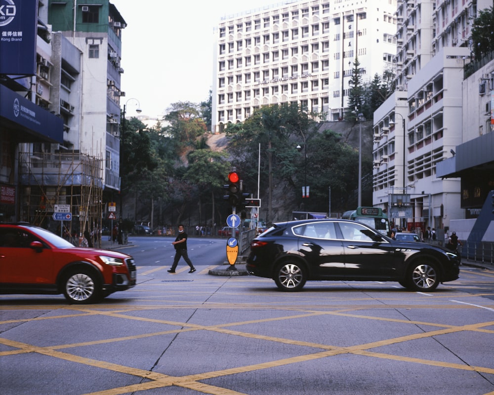a black car is stopped at a red light